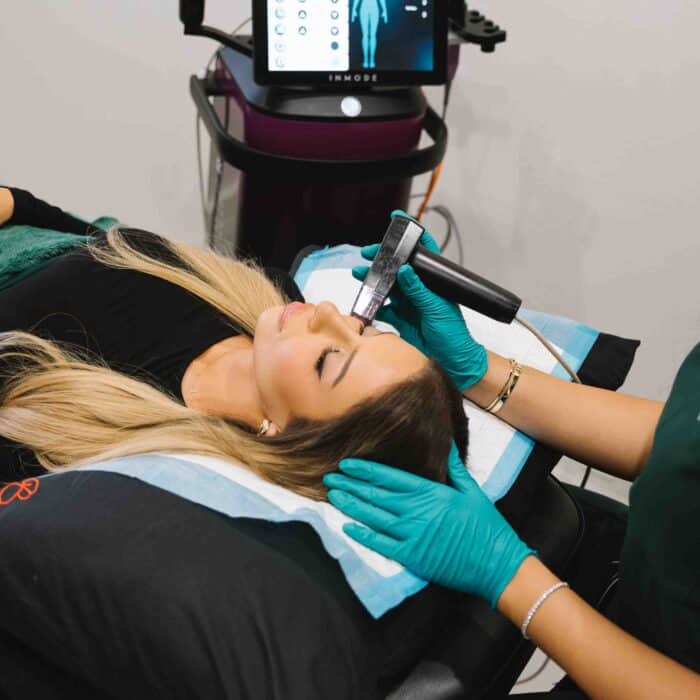 Client receiving a professional cosmetic treatment at a skin care clinic to enhance skin appearance and texture.