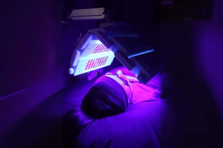 Client receiving blue light LED therapy at Biba Cosmetic Solutions.