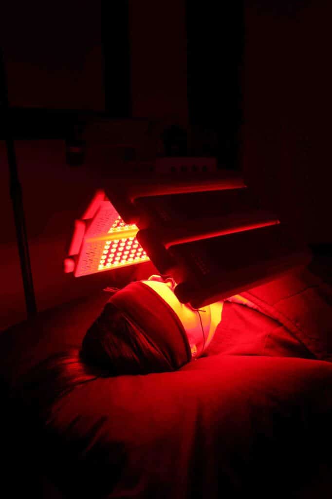 A client receiving red light therapy as part of a comprehensive skin care clinic treatment to enhance skin health and slow the signs of ageing.